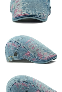 Macro detail of washed denim beret featuring pink splatter pattern and metal buckle