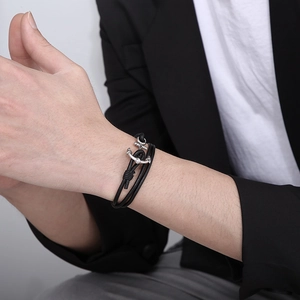 Men's multilayer black leather anchor bracelet with silver clasp on a male wrist