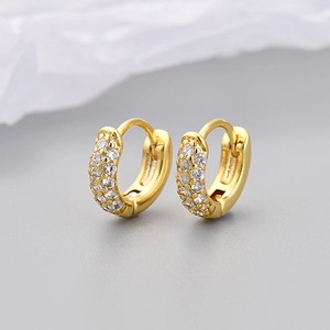 Detail of gold-plated hoop earrings featuring three rows of micro-pave cubic zirconia
