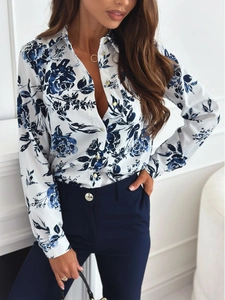 Detail of floral printed shirt with long sleeves and elegant gold buttons on cuffs
