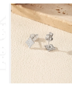 Macro shot of 925 silver poker diamond stud earrings with micro-set stones and butterfly back