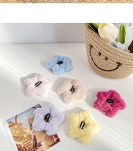 Close-up of plush flower hair clips in six pastel colors with metal duckbill base