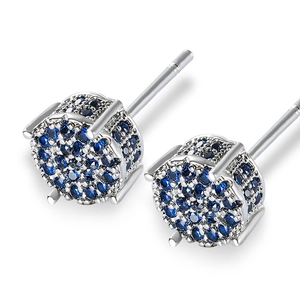 Macro shot of silver stud earrings with pave-set dark blue cubic zirconia stones