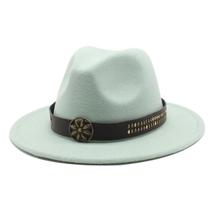 Close-up of mint green felt fedora featuring a vintage floral buckle and metal rivets