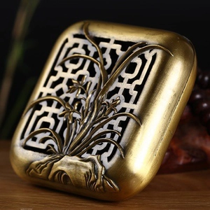Detailed macro of hollow-out orchid carvings on a bronze incense burner lid