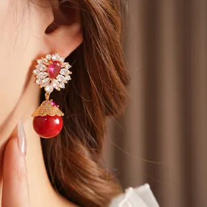 Vintage gold-tone drop earrings with red stones and flower-shaped zircon studs