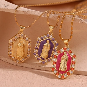 Detail of 18K gold plated Virgin Mary pendants with colorful enamel and crystals