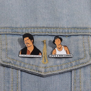 Detail of Blood In Blood Out movie character enamel pins on a blue denim jacket