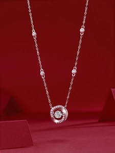 Detailed view of sterling silver necklace with 1-carat moissanite on red display stand