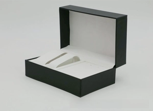 Detail of black PU leather watch box with white flocking interior and dual watch pillows