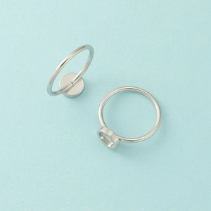 Macro shot of silver stainless steel ring blanks with round bezel settings for DIY jewelry