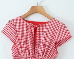 Detail of red gingham dress with back bow tie design and smocked elastic texture