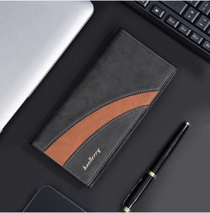 Business style long wallet for men in black and brown leather on an office desk