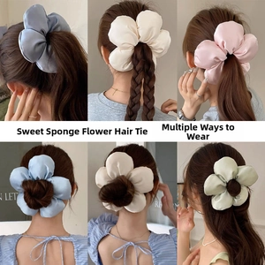 Detail of satin floral scrunchies showing 3D sponge padding and elegant hair styling options