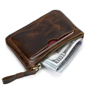 Macro shot of dark brown genuine leather coin purse with zipper and precise stitching