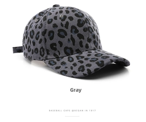 Detail of grey corduroy baseball cap with blue and black leopard print pattern