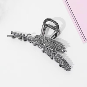 Detailed view of large dark silver hair claw clip with rhinestones in wheat ear design