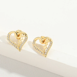 Detail of gold heart stud earrings with love script and sparkling crystal border