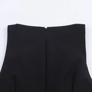 Detailed macro view of the high-quality invisible zipper on a black fabric garment