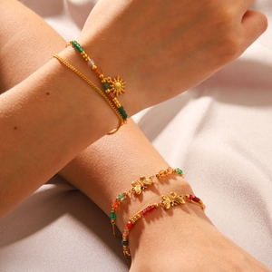 French style natural stone beaded butterfly bracelet set shown on model on silk background