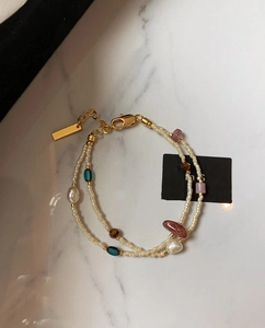 Detail view of bohemian double-layer bracelet with pearls and adjustable lobster clasp