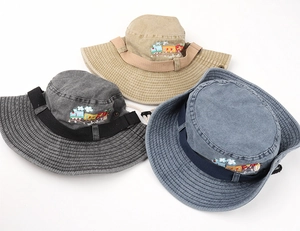 Three washed cotton bucket hats with colorful train embroidery and adjustable chin straps