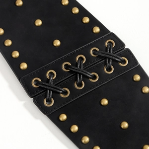 Macro view of black PU leather waist belt with gold studs and lace-up front detail