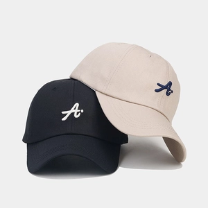 Detailed close-up of 3D letter A embroidery on black and beige cotton baseball caps