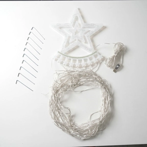 Detail of Christmas star tree topper with LED string lights, USB plug, and ground stakes