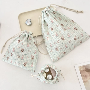 Three mint green drawstring bags with animal patterns for makeup storage organization