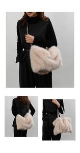 Close-up of plush faux fur tote bag with golden chain strap and woven handles