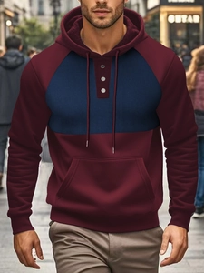 Detailed shot of men's color-block hoodie with button neckline and kangaroo pocket