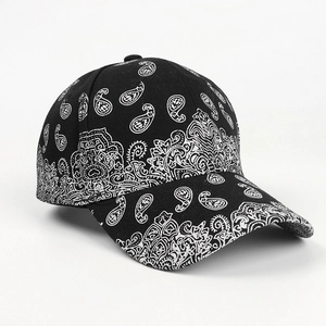 Detail view of vintage paisley pattern on black and white cotton twill baseball cap