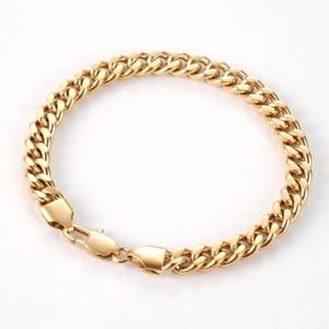 Detailed view of gold Cuban link bracelet featuring a polished finish and lobster clasp