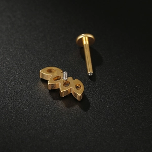 G23 titanium golden moon labret stud with zircon leaf design on dark background