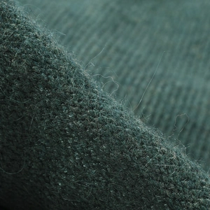 Dark green angora knit beanie with soft plush texture and fuzzy mohair finish