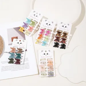 Detailed set of 6 small butterfly hair clips in various colors on cat shaped cards