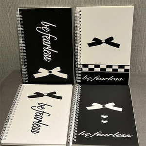Detail of A5 spiral notebooks set with pink bows and minimalist black white patterns