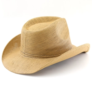 Close-up of woven straw texture and classic dented crown on a vintage western cowboy hat