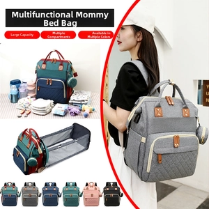 Multi-functional diaper bag showing foldable baby bed and large capacity storage compartments