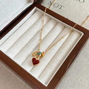 18k gold plated necklace with red heart pendant and colorful beads in a wooden box