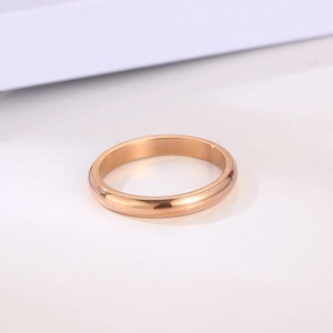 Minimalist rose gold titanium steel ring with a smooth polished finish on white background