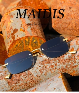 Detail of rimless square sunglasses with grey lenses on industrial metal pipes