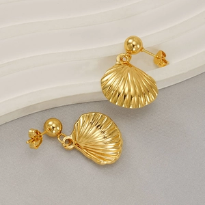 Modern gold stainless steel shell drop earrings displayed on a white wavy pedestal
