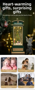Green Christmas telephone booth music box with light, snowing tree and snowman scene
