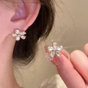Elegant silver flower stud earrings with sparkling crystal petals and center diamond