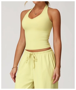 Close-up of light yellow V-neck halter sports bra and high-elastic yoga wear details