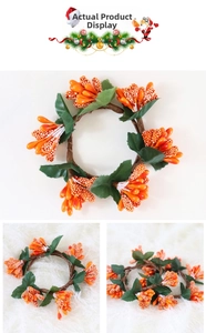 Detail of handmade orange berry wreath with green leaves for autumn table decoration