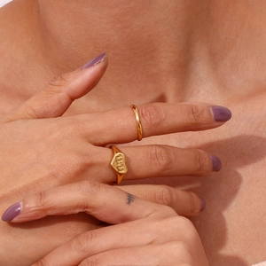 Detail of 18K gold plated stainless steel heart ring with 11:11 engraving on finger