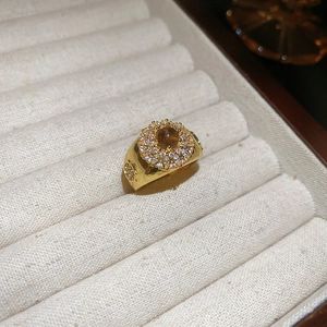 Detail macro of 18k gold plated ring with brown tiger eye stone and zircon micro-pave